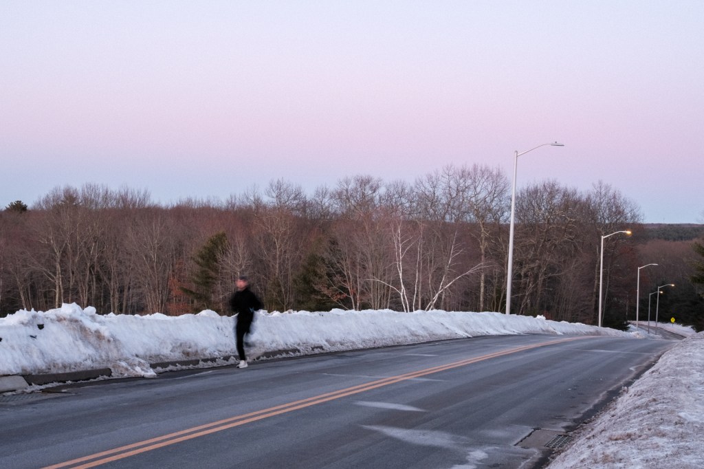 Author running up hill at sundown